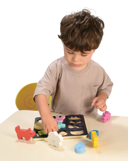 Child playing with wooden shape sorting toy on a white background