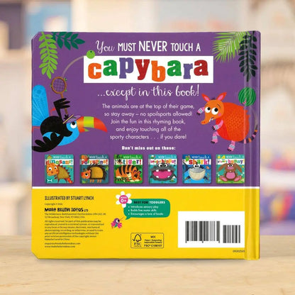 Back cover of a children's book titled 'You Must Never Touch a Capybara' with colourful illustrations on a blurred background.
