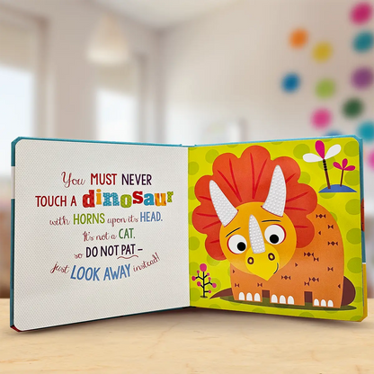 Children's book with a colourful dinosaur illustration and text on a wooden surface.