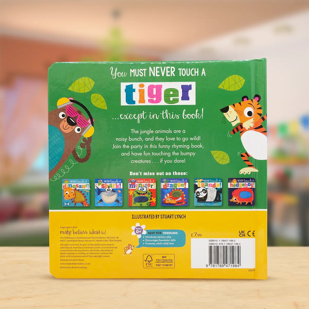 Back cover of a children's book with colourful illustrations and text on a wooden surface.