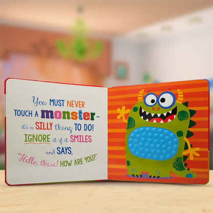 Children's book with a colourful monster illustration and text on a wooden surface.