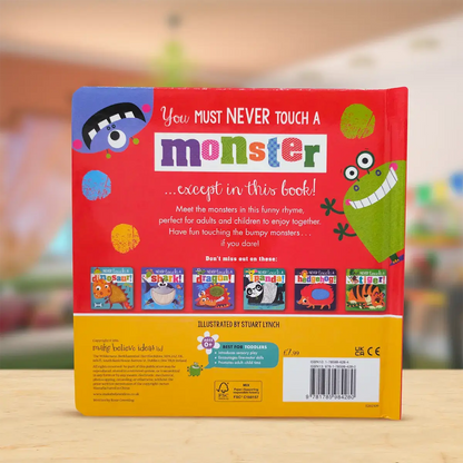 Back cover of a children's book titled 'You Must Never Touch a Monster' with colourful illustrations on a wooden surface.
