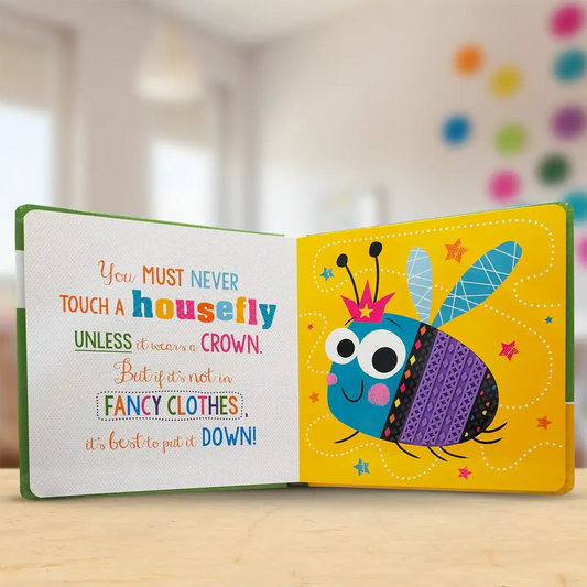 Children's book with a colourful bee illustration and text on a wooden surface.