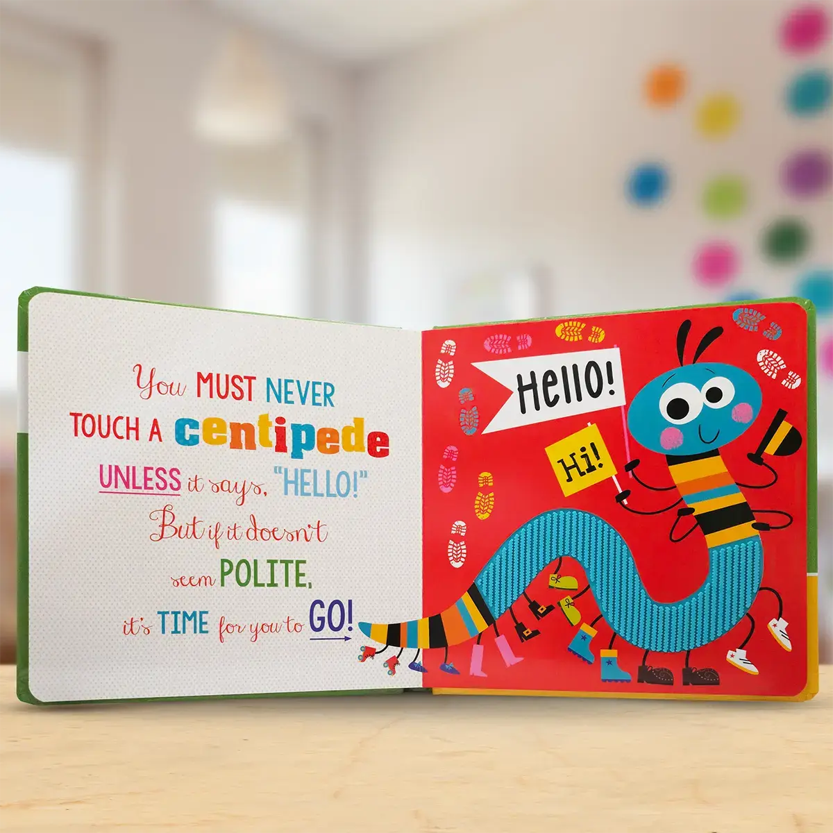 Children's book with colourful illustrations and text on a wooden surface.