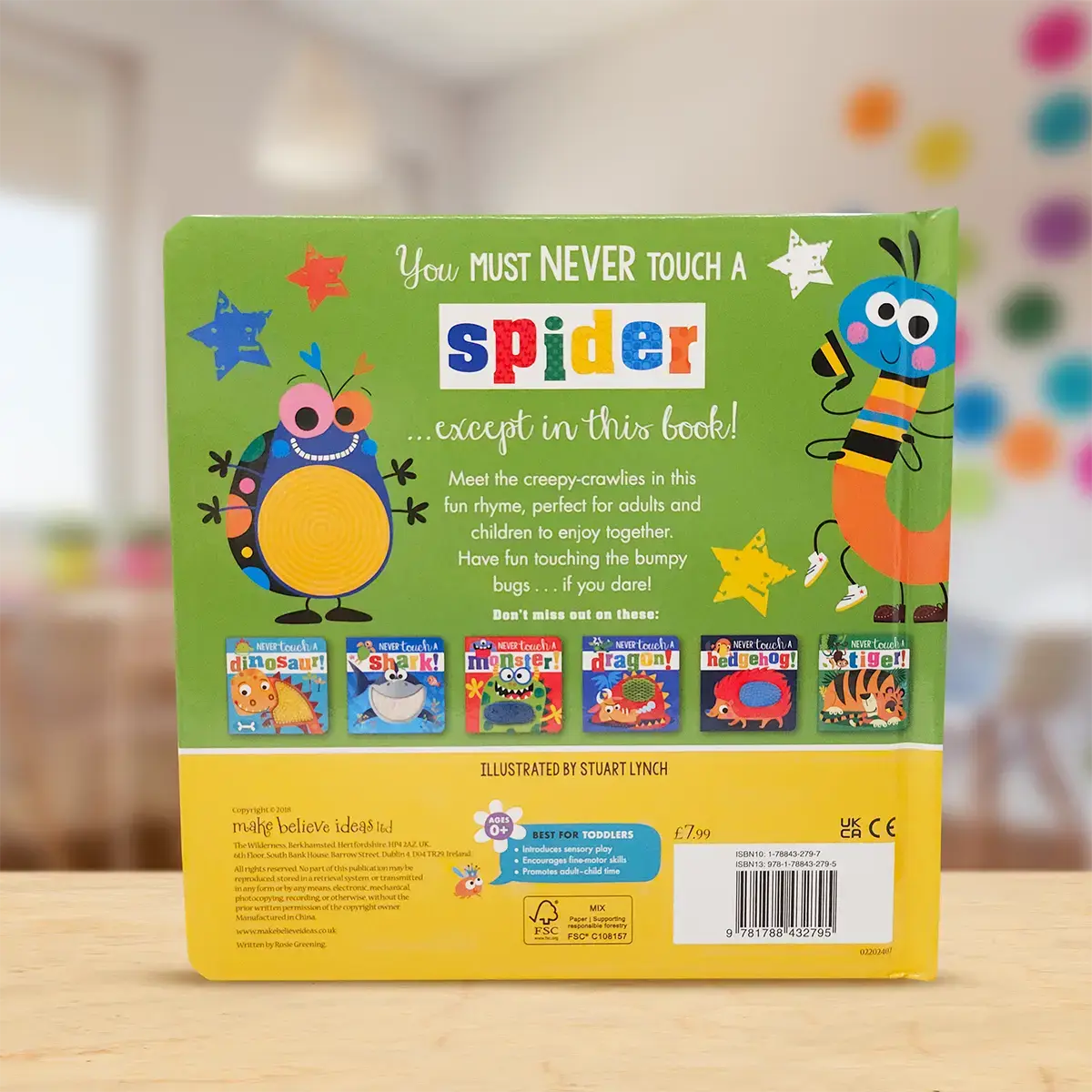 Book cover with colourful illustrations and text on a blurred indoor background