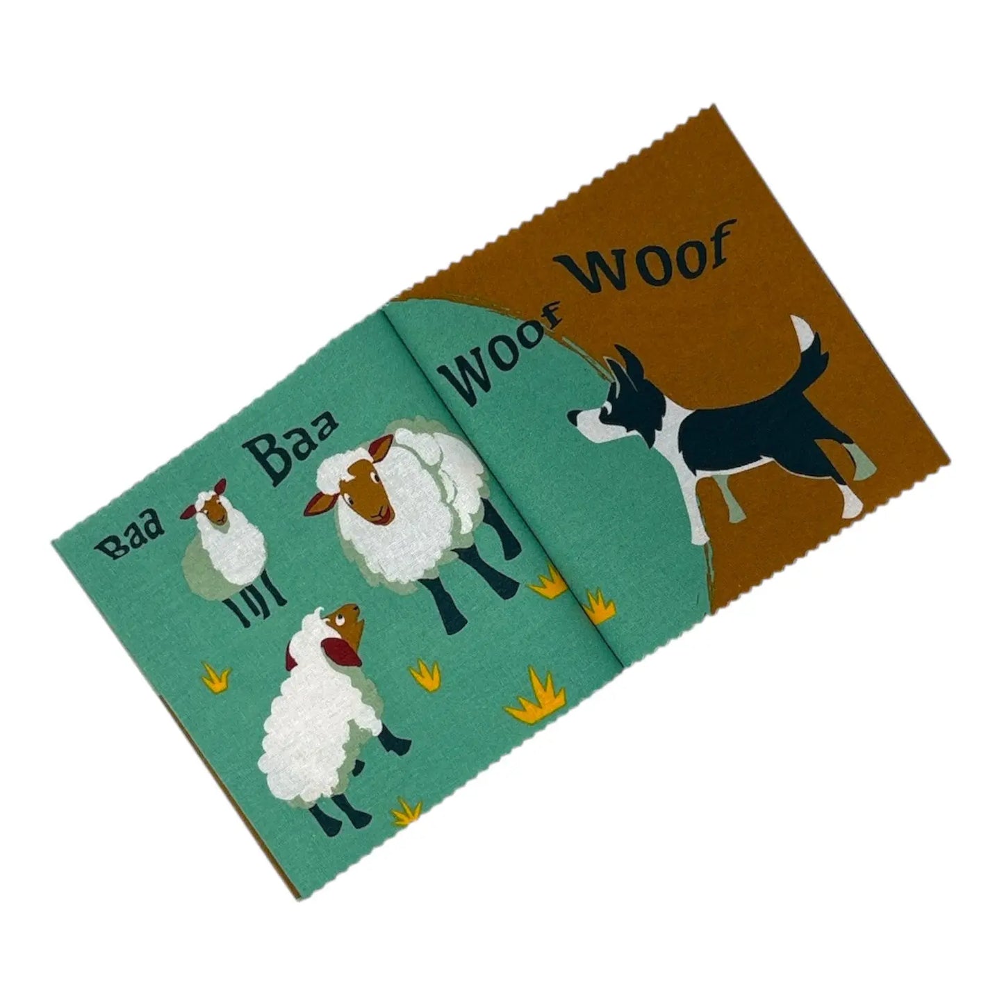 A children's fabric book with a playful sheep and dog theme, shown open on a plain white background. The left panel is teal with illustrations of three white sheep and the word 'Baa' repeated.