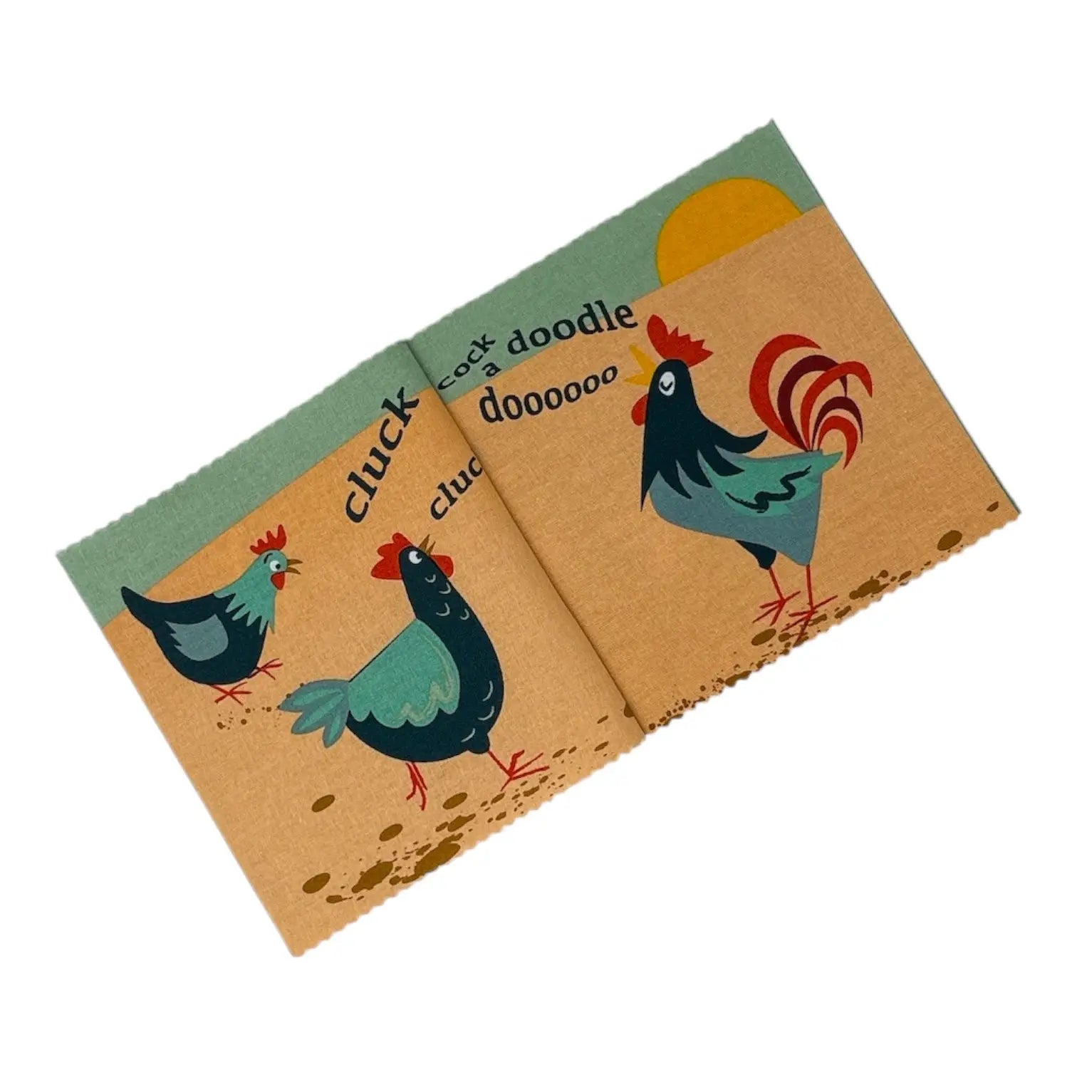 A cloth book featuring a whimsical chicken illustration with the words 'cluck', 'doodle', and 'cluck doooooo' printed on a kraft-paper style background.