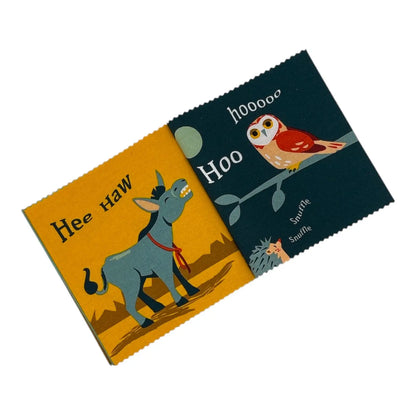 Childrens cloth book with serrated edges, featuring a yellow cover with a blue donkey and the text 'Hee Haw', and a dark blue cover with an owl, the word 'Hoo', and the text 'Snuffle Snuffle'.