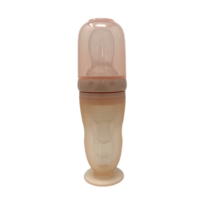 Multi-functional silicone baby bottle with a standard nipple, soft spoon feeder, and fruit feeder attachment.