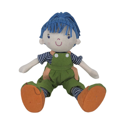 Toy doll figure with blue hair, striped shirt, green overalls, and orange shoes on a white background