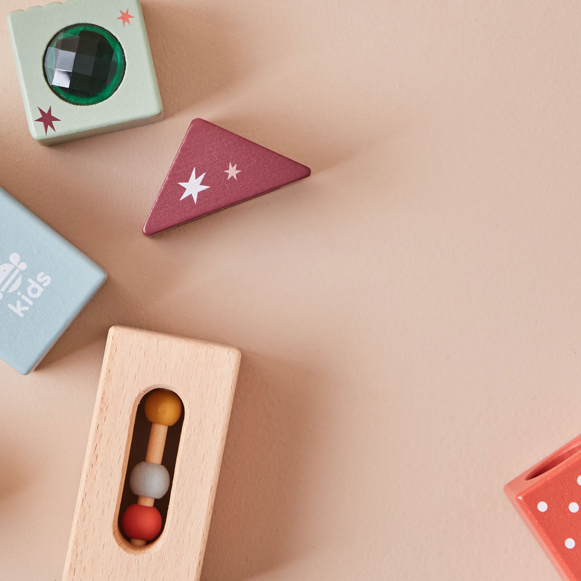 Colourful wooden toys on a beige surface