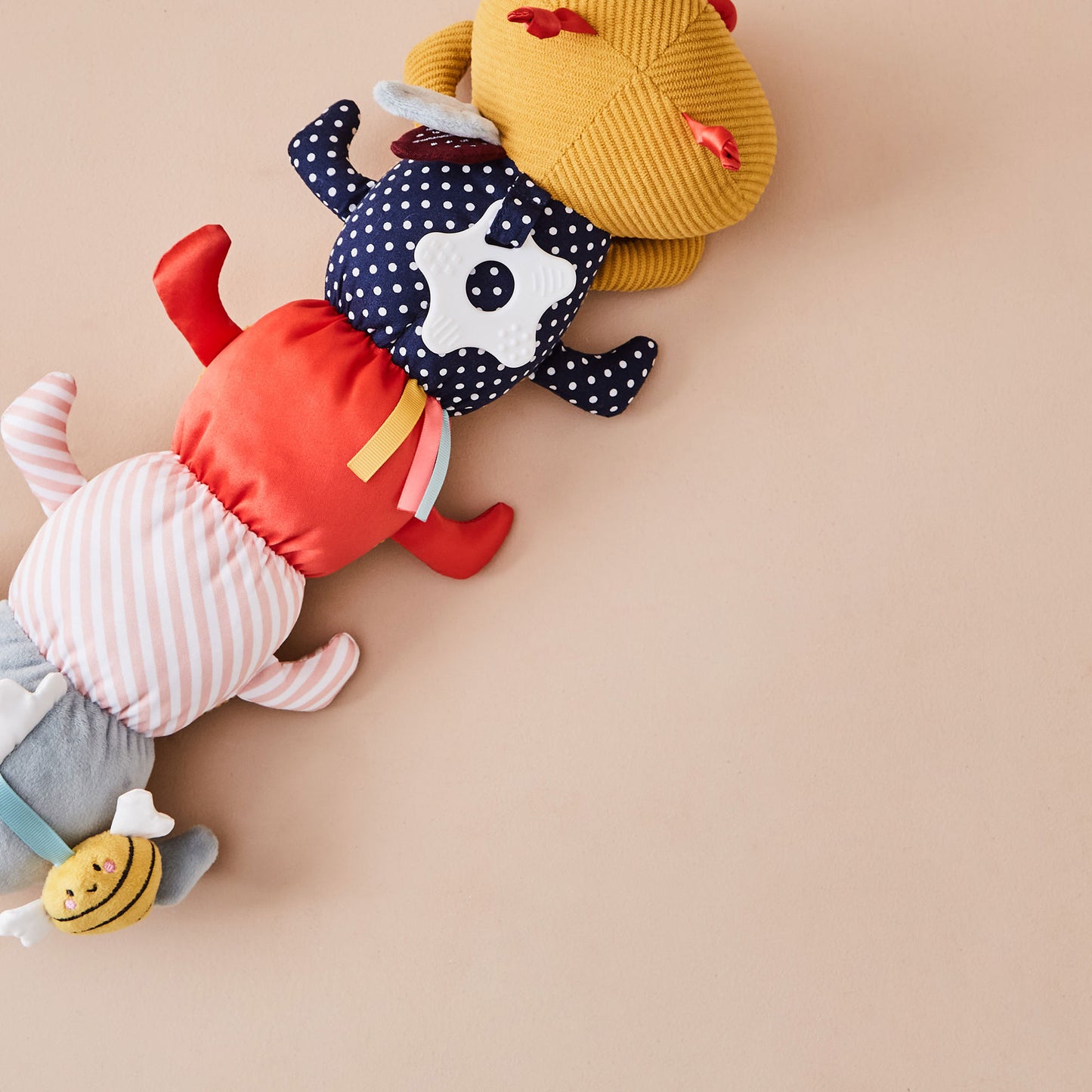 Colourful plush toy on a beige background