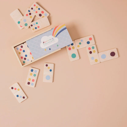 Wooden dominoes with colourful dots on a beige background