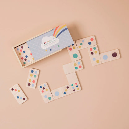 Wooden dominoes with colourful dots on a beige background