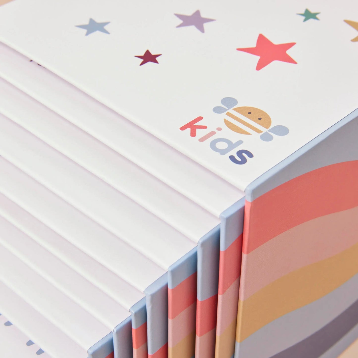 Children's stacking boxes with colourful star patterns and 'just bee kids' branding.