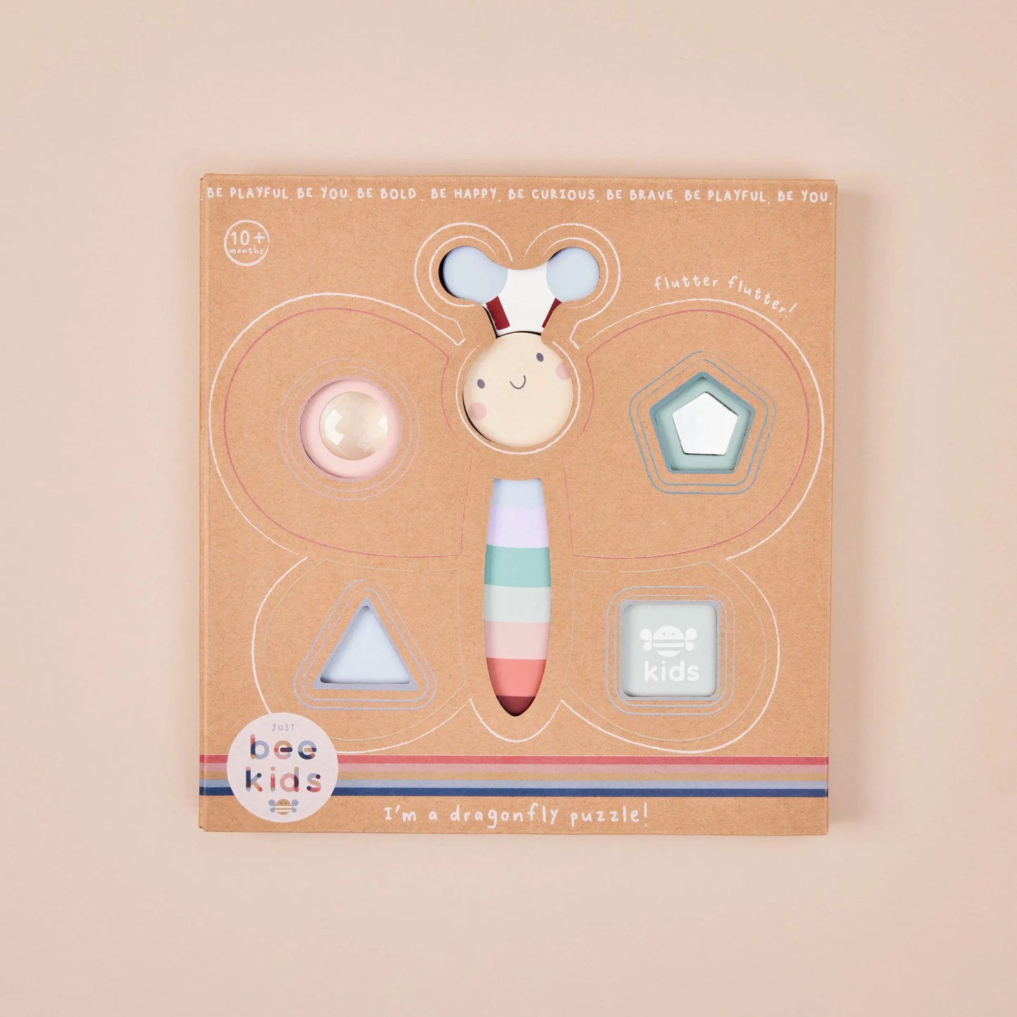 Dragonfly-shaped puzzle packaging with colourful dragonfly figure on a beige background