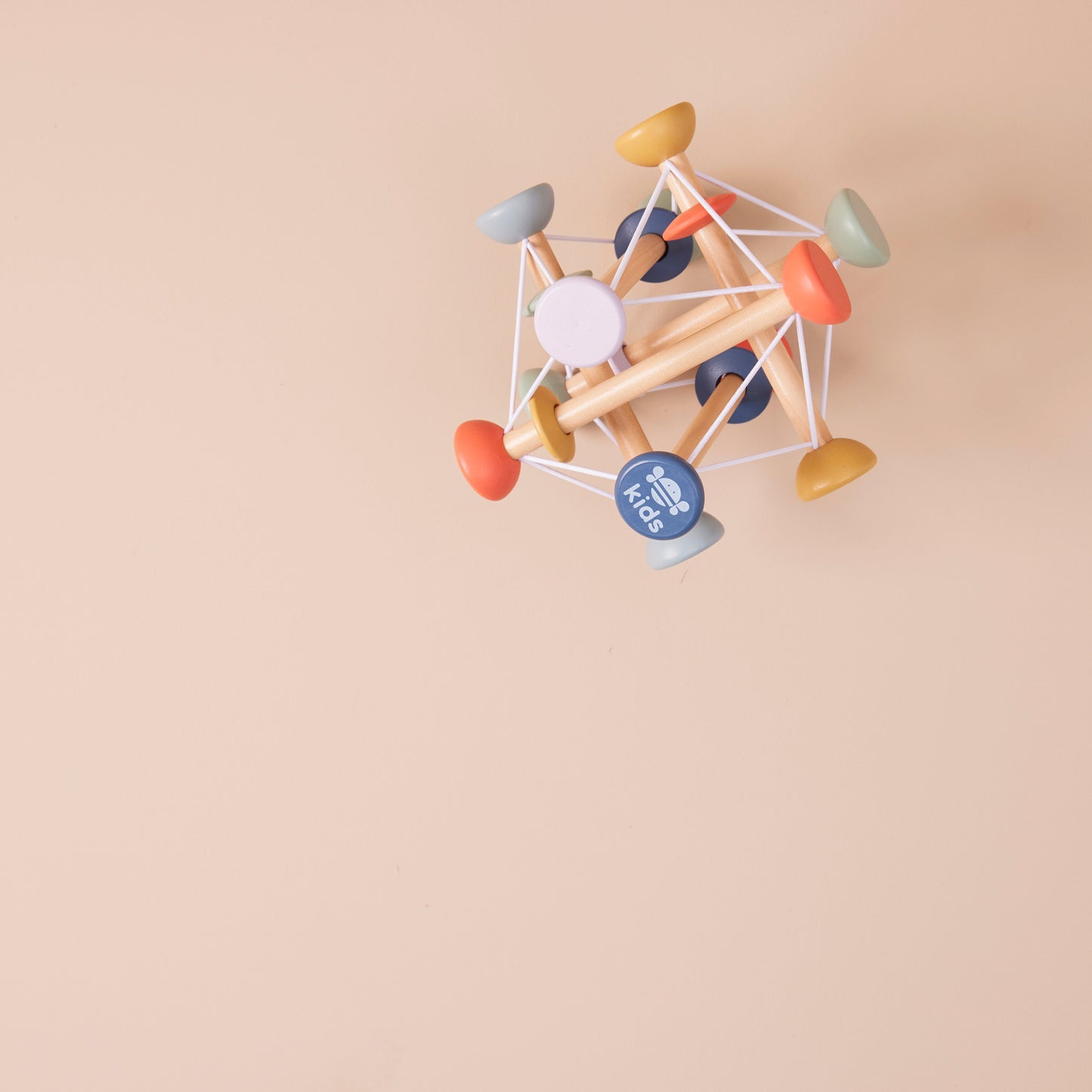 Colourful geometric wooden activity toy on a beige background