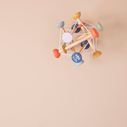 Colourful geometric wooden activity toy on a beige background
