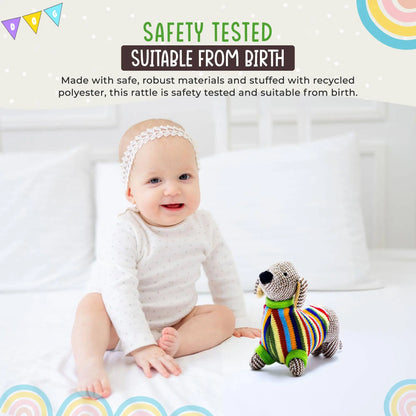Baby sitting on a white blanket with a colourful striped toy, surrounded by safety testing text and rainbow graphics.