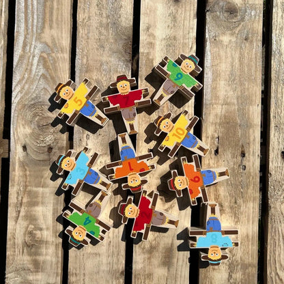Colorful wooden puzzle pieces shaped like people on a wooden surface