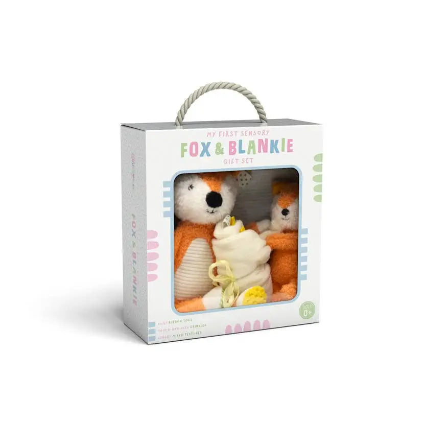 Gift set with fox plush toy and blanket in a box on a white background