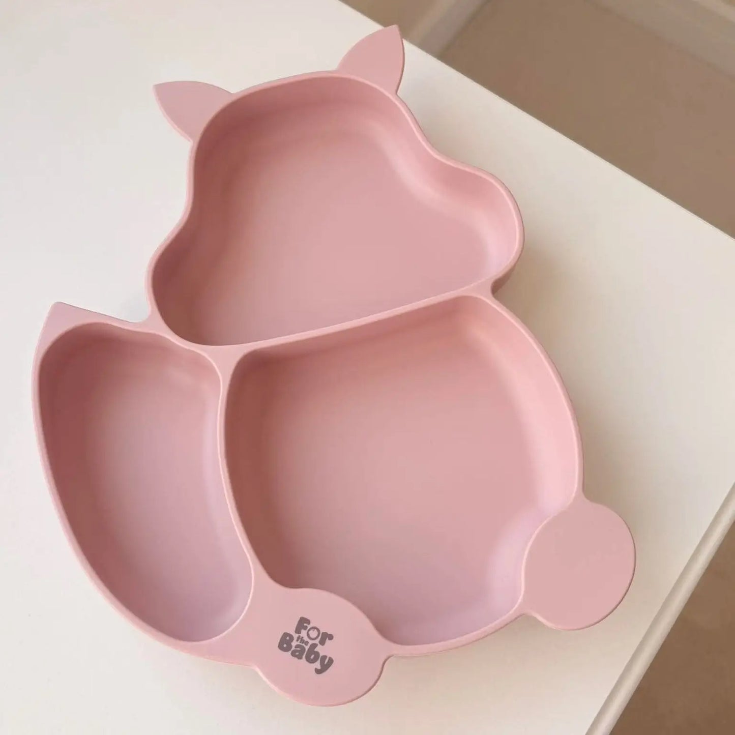 Pink baby suction bowl bowl on a white surface