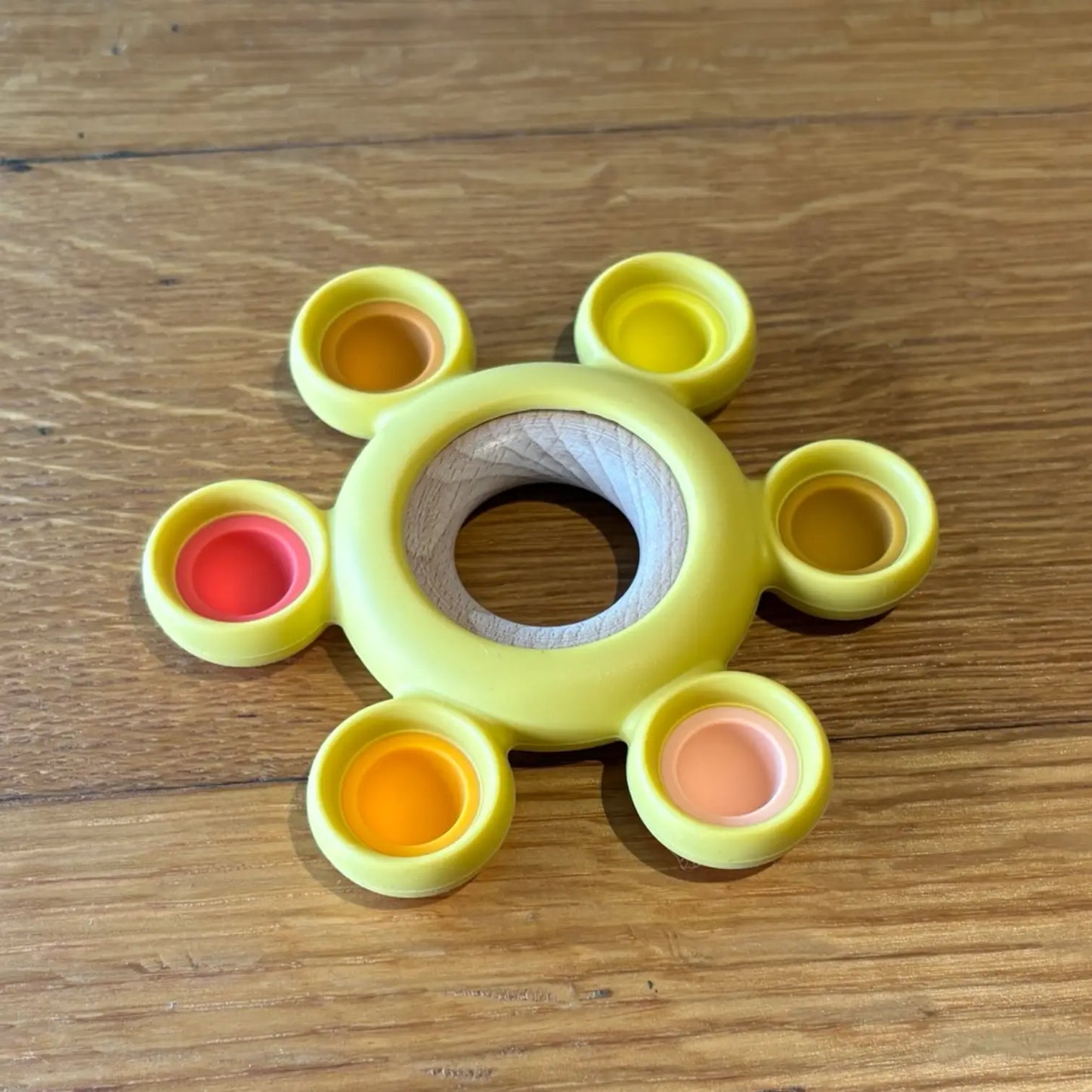 Silicone wood teether On wooden surface