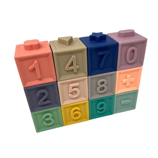 Colourful toy blocks with numbers and mathematical symbols on a white background