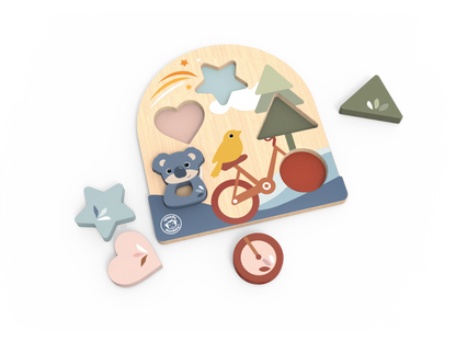 A wooden children's puzzle board with cutout shapes and matching loose pieces, including a heart, star, triangle, clock, and bird-themed bicycle scene, photographed on a clean white background.
