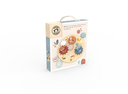 A boxed children's wooden puzzle toy shown on a clean white background. The package is mostly cream and light blue, with a circular window displaying colourful wooden gear pieces and a small handle on top.