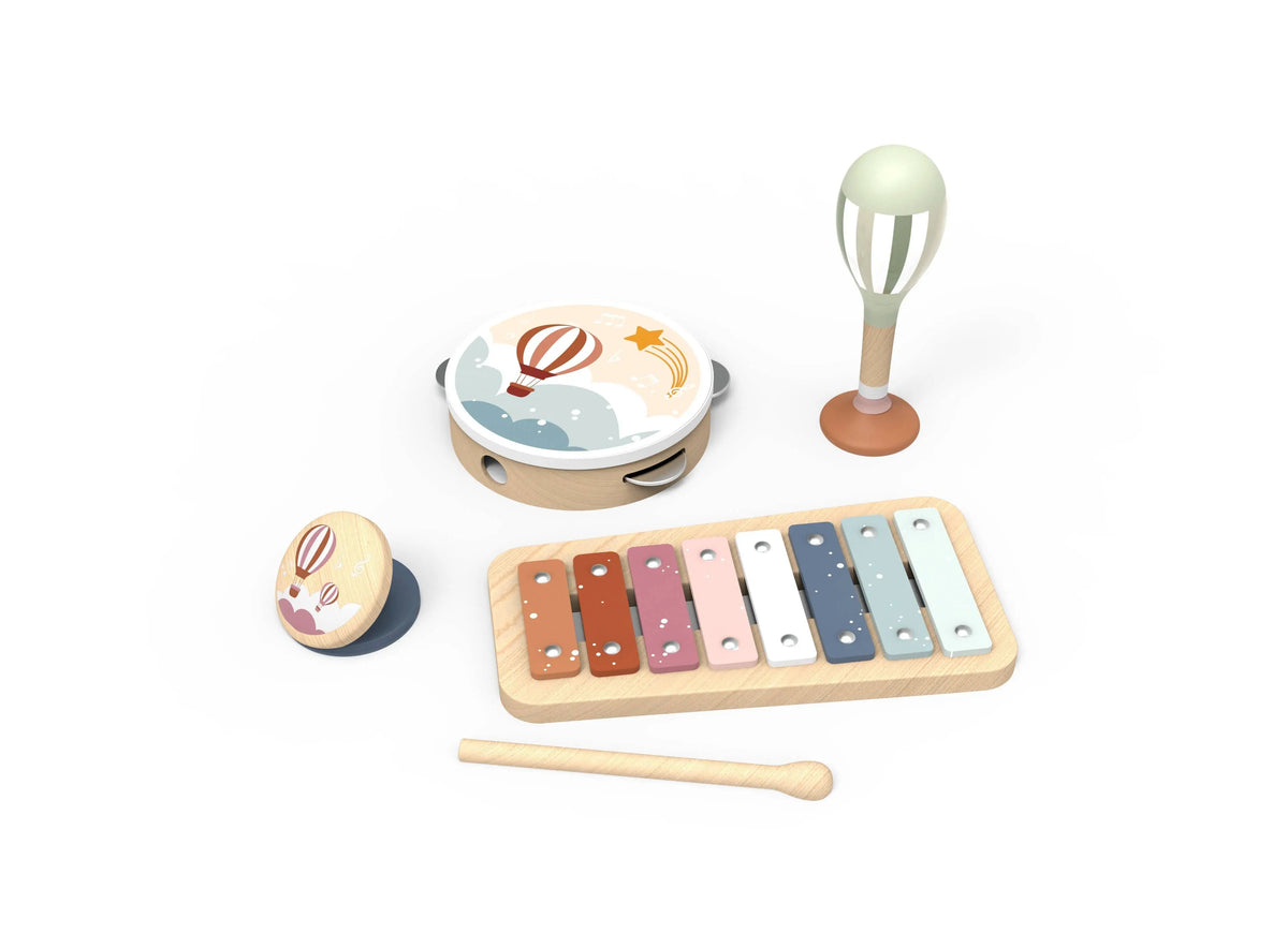 A wooden toy music set on a white background, including a xylophone with colorful keys, a tambourine with a hot air balloon design, a maraca, and a small round wooden toy with a bunny face.