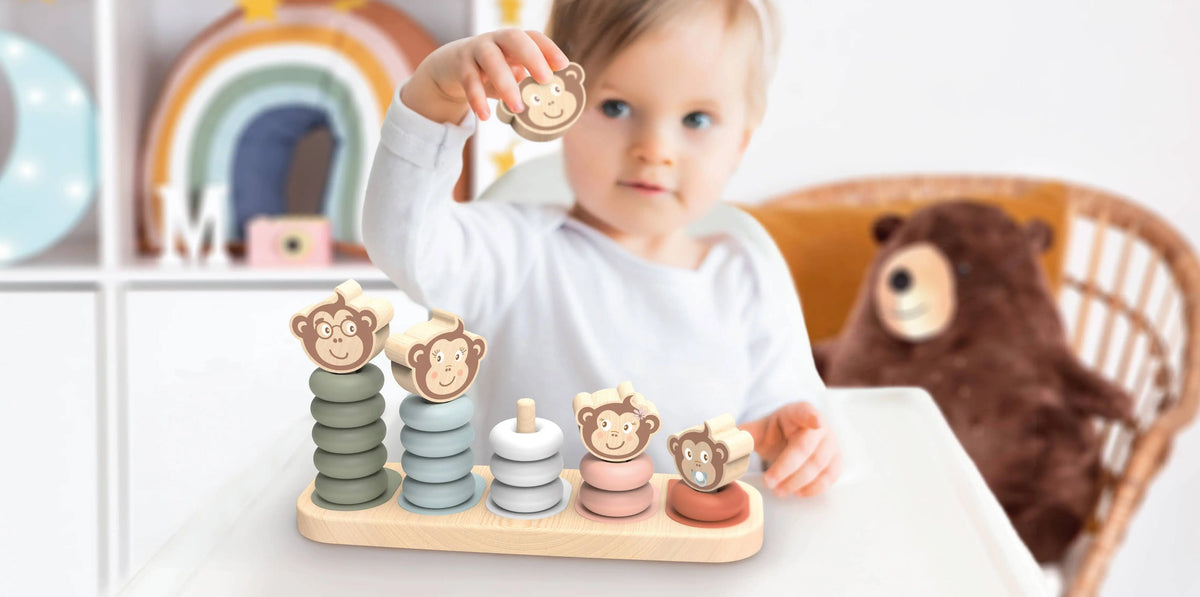 Child playing with a wooden toy set in a cozy room with a teddy bear and colourful decor.