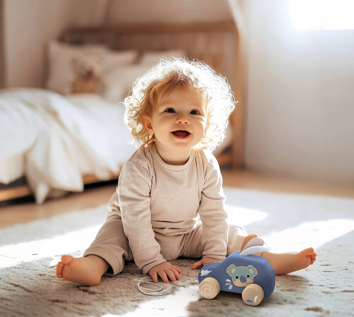 Child playing with a toy car on a carpeted floor