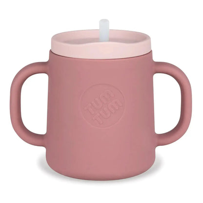 Pink children's cup with handle and straw lid on a white background