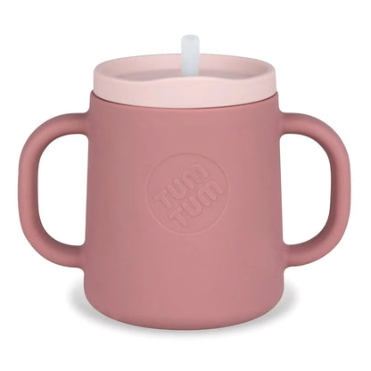 Pink children's cup with handle and straw lid on a white background