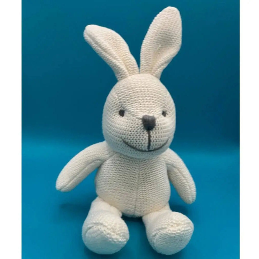 Knitted bunny toy on a blue background
