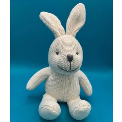 Knitted bunny toy on a blue background