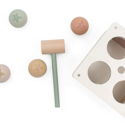 Wooden mallet with star-shaped wooden balls on a white background