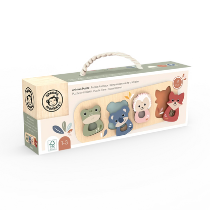 Box of wooden toys with animal designs on a white background