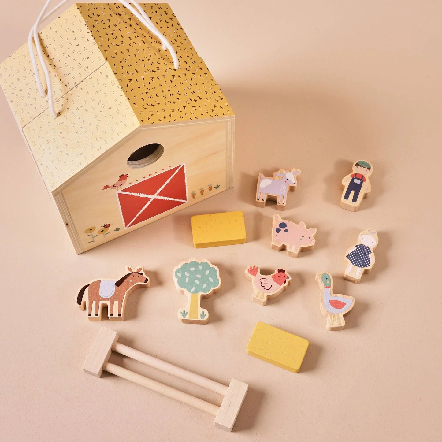 Wooden toy set with various shapes and figures on a beige background