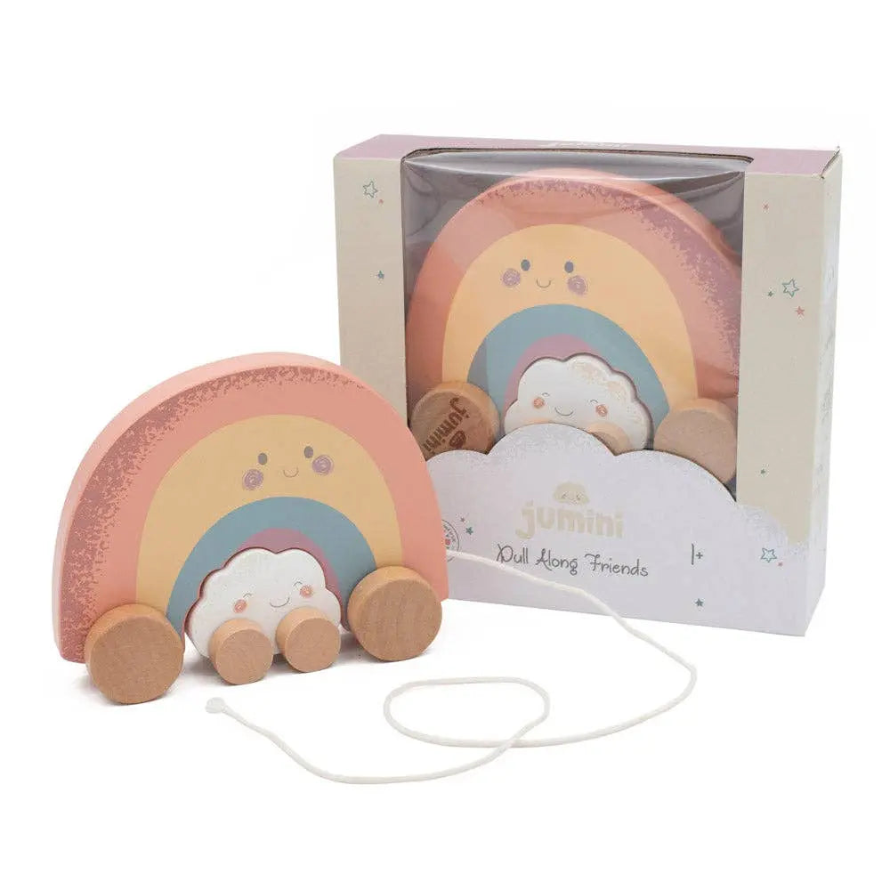 Rainbow-shaped toy with wheels and a cloud, in front of its packaging on a white background