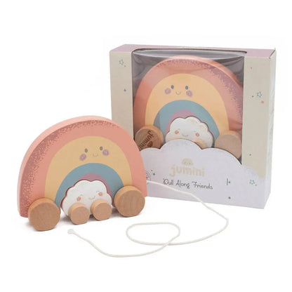 Rainbow-shaped toy with wheels and a cloud, in front of its packaging on a white background
