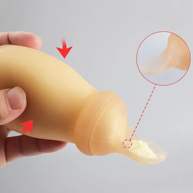 Soft silicone spoon feeder attachment dispensing pureed food for easy self-feeding.