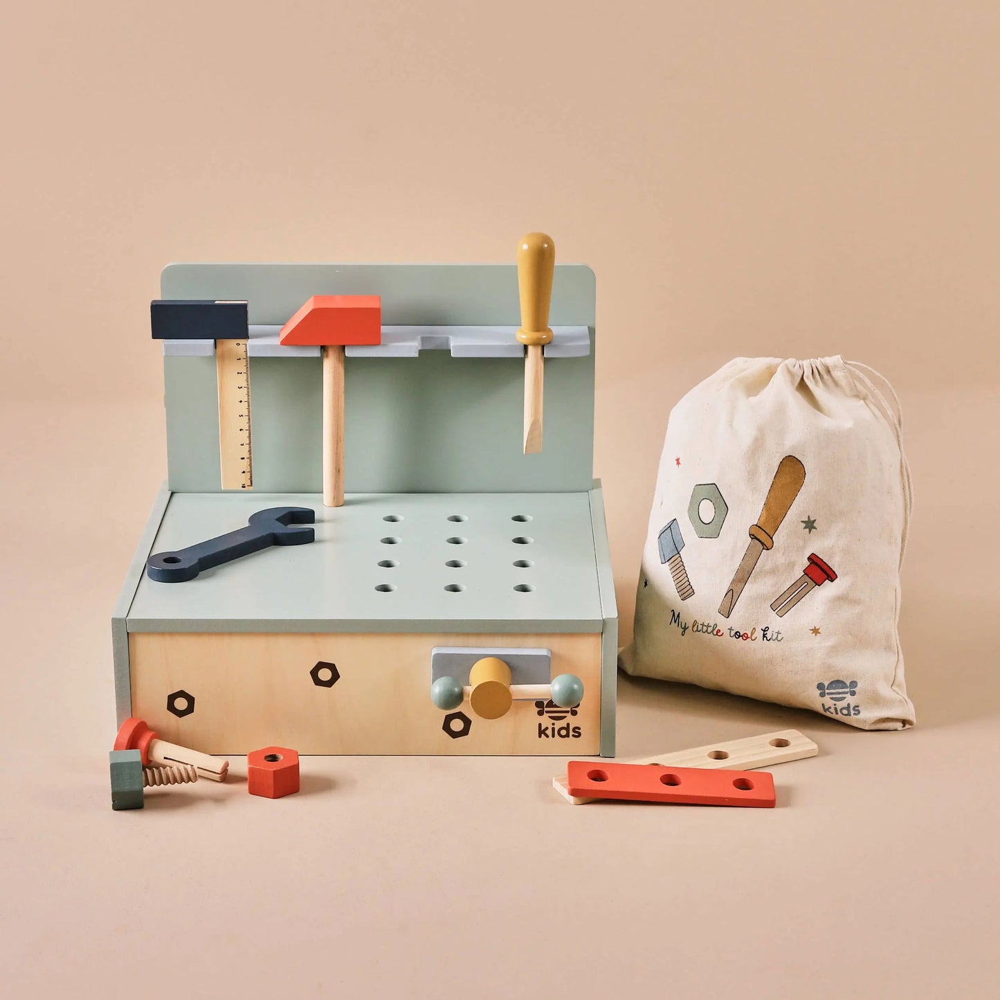 Children's toy tool set with tools and accessories on a beige background