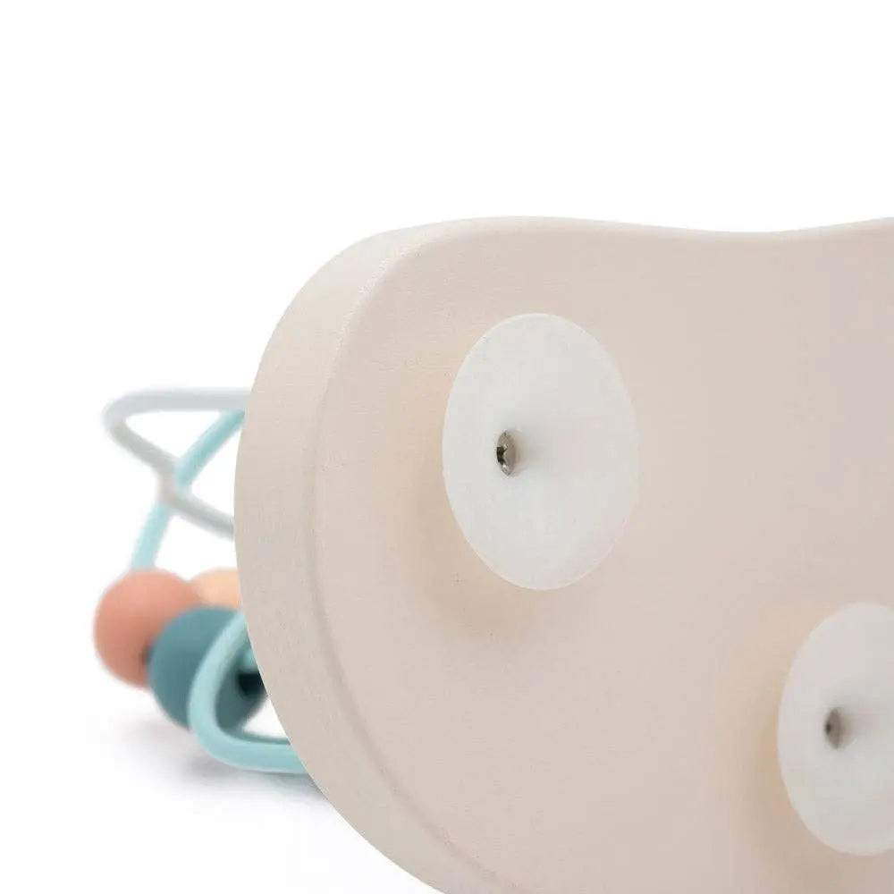Close-up of a beige baby toy with colourful beads on a white background