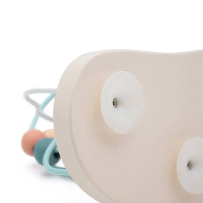 Close-up of a beige baby toy with colourful beads on a white background