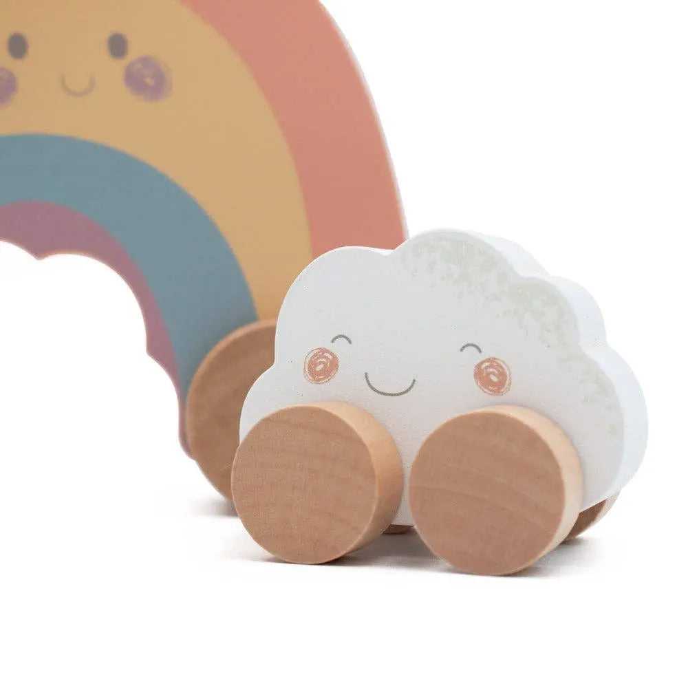 Toy cloud with wheels and rainbow in the background