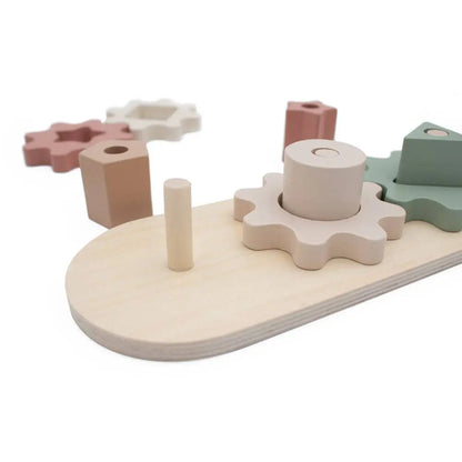 Wooden shape sorting toy with pastel-coloured blocks on a white background
