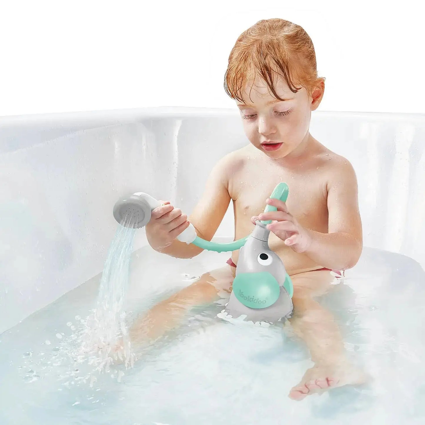 Child playing with a toy shower head in a bathtub