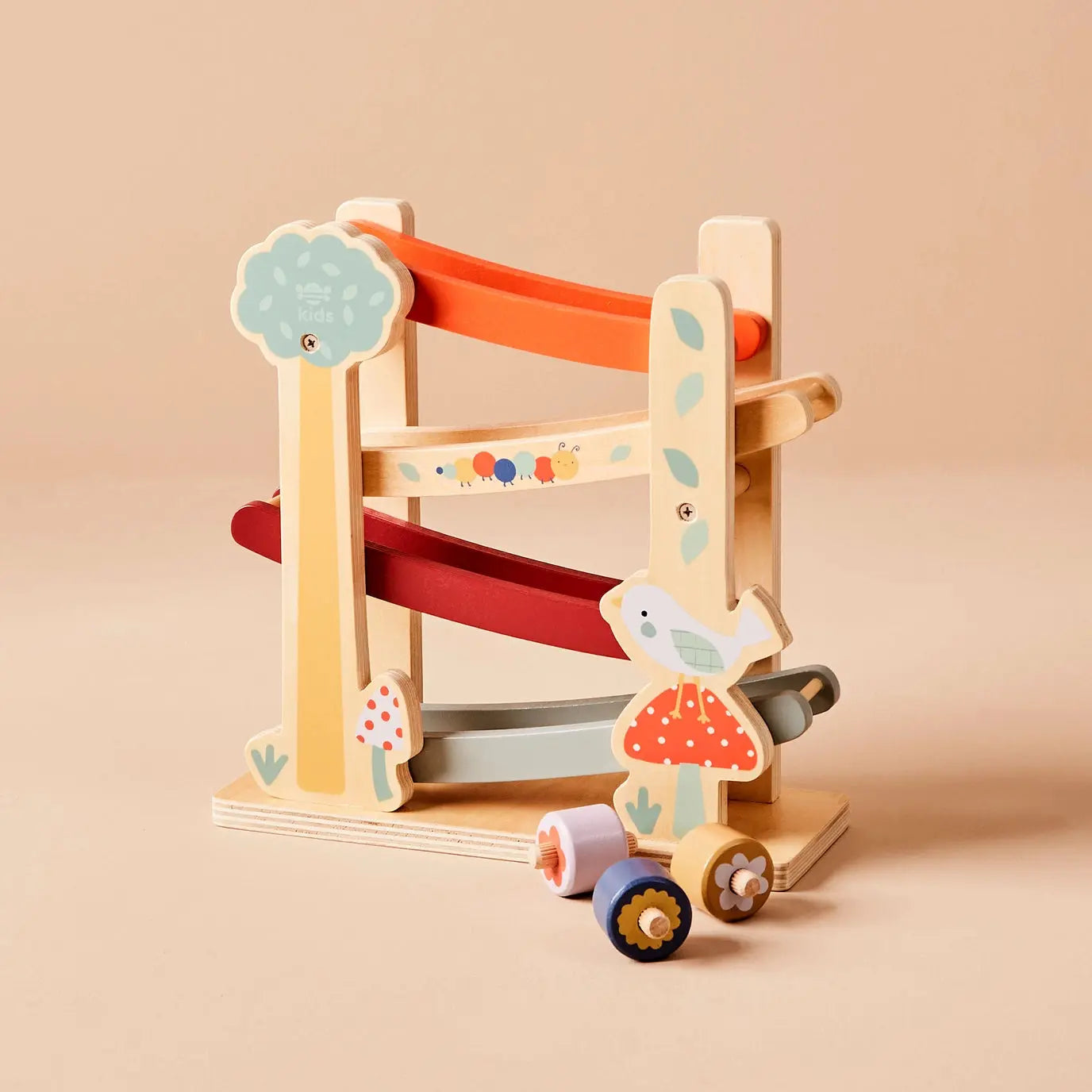 Wooden toy with a slide and colourful design on a beige background